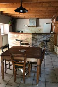 a wooden table and chairs in a kitchen at La grange in Bio