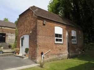 a brick building with a white door and windows at Lower Bell in Aylesford +4 photos