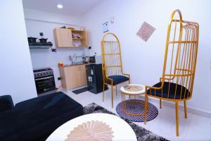 a living room with two chairs and a couch at First class apartments in Kiambu
