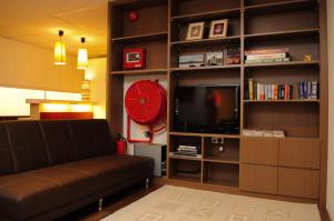 a living room with a couch and a red clock at River City Inn in Singapore