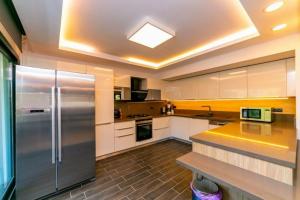 a large kitchen with a stainless steel refrigerator at Villa Diamond in Marmaris