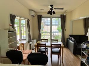 a living room with a table and chairs and a couch at Kotori Cottage in Hakuba