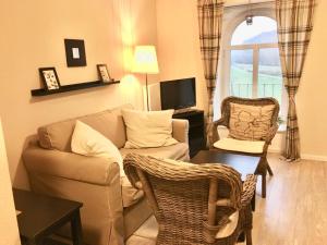 a living room with a couch and chairs and a table at Station L in Langballig