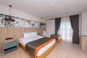 Postel nebo postele na pokoji v ubytování Lims Bona Dea Beach Hotel