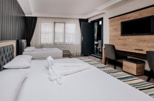 Postel nebo postele na pokoji v ubytování YILDIZ SUİTE & APART