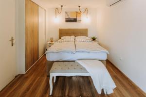 a bedroom with a large bed and a wooden floor at Vista Lago,Orahovica jezero in Duzluk