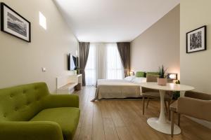 A bed or beds in a room at Alma Suites