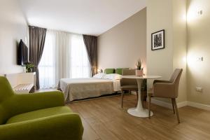 A bed or beds in a room at Alma Suites