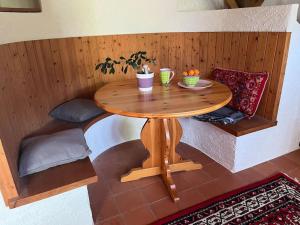 a small wooden table in a room with a tableablish at Charming alps apartment perfect for walk/cycle/ski in Eschenbach