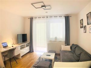 a living room with a couch and a desk at Apartment Centro - YOUR 2nd HOME in GRAZ in Graz