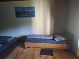 a bedroom with a bed and a painting on the wall at Domček pod lesíkom in Banská Štiavnica