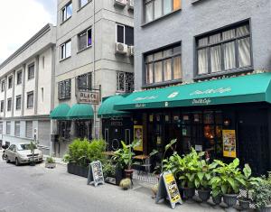 a store with green umbrellas in front of a building at Black Art Otel in Istanbul