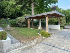 a wooden pavilion in a park with a garden at B&B NAR in Como