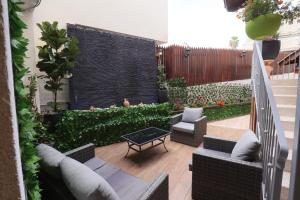 a small backyard with a patio with chairs and a table at Mary's Well Apartments in Nazareth