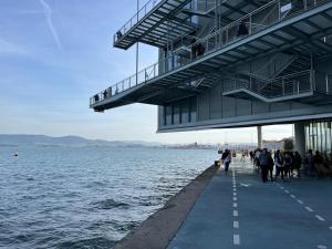 a group of people walking on a pier next to the water at Apartamento con encanto 2 hab céntrico-ayuntamiento in Santander