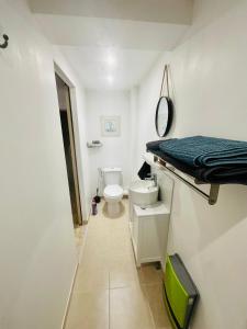 a bathroom with a toilet and a bed in it at Studio Torreilles village in Torreilles