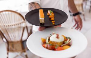 a person holding a plate with a dessert on it at Villa Sainte Anne in Porquerolles
