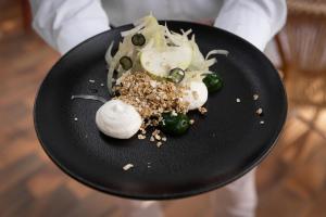 a plate of food with vegetables and garlic on it at Villa Sainte Anne in Porquerolles