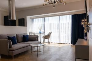 a living room with a couch and a table at Oban Apartments in Oban