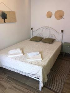 a bedroom with a bed with two pillows on it at A Casa do Barqueiro- Alentejo in Pedrógão +24 photos