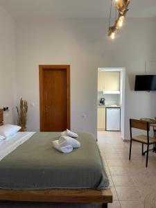 a bedroom with a bed with two towels on it at Platanos in Samothraki