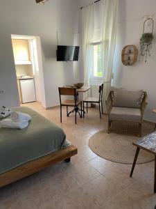 um quarto com uma cama, uma mesa e cadeiras em Platanos em Samotrácia