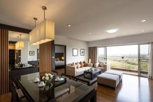 a living room with a couch and a table at Kantary Hotel Kabinburi in Kabin Buri