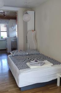 a large bed with a black and white comforter in a room at Apartma 198 in Kranjska Gora