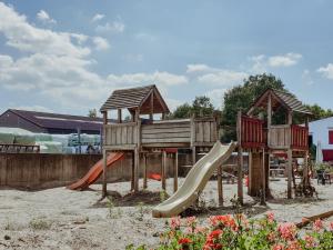 a playground with a slide in the sand at Hof ter Pierlapont Brugge by Feather Down in Zedelgem