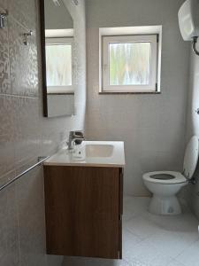 a bathroom with a sink and a toilet and a window at La Meridiana IUN P2300 in Cala Gonone