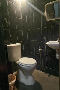 a bathroom with a toilet and a sink at Dongfang Motel in Kuala Lumpur