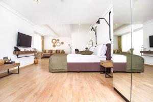 a bedroom with two beds and a living room at Olive Villas Beach Hotel in Sozopol
