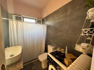 a bathroom with a sink and a toilet and a shower at Marble's Residence in Argostoli +23 photos