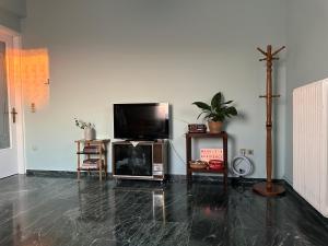 a living room with a flat screen tv and a cross at Marble's Residence in Argostoli