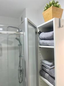 a bathroom with a shower and some towels at Lookout Point Tenerife Holiday Apartment Las Americas in Playa Fañabe