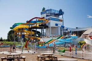 a water park with slides and tables and people at Vellior Residence in Jūrmala