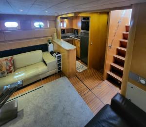 a living room with a couch and a kitchen at Hébergement Yacht in Cogolin