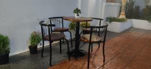 a small table and two chairs on a patio at Villa Samnang BOUTIQUE HOTEL in Phnom Penh