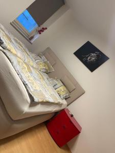 a small bedroom with a bed and a red drawer at Appartement Trier Zentrum ( mit Mosel Blick ) in Trier