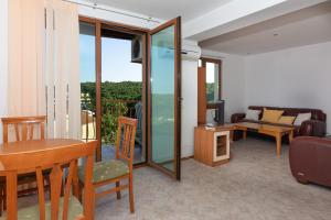 a living room with a table and a couch at Частен апартамент в затворен комплекс in Sinemorets