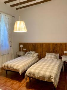two beds sitting next to each other in a bedroom at Casa Monegros in Lastanosa