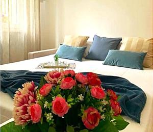 a bouquet of flowers sitting on top of a bed at Suite Cinque terre Portovenere in La Spezia