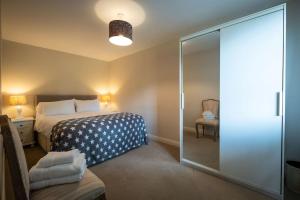 a bedroom with a bed and a glass shower at Apple Cottage -- Luxury Stay @ Bellingham Castle in Castlebellingham
