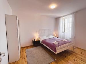 a bedroom with a bed and a window at Zamaria Apartments in Vis