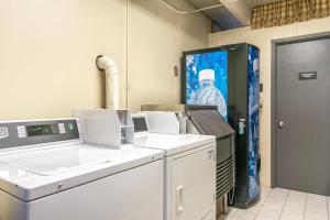 a laundry room with machines and a picture of a man at Lift House Lodge, Vail Lionshead Studio Condo, Walk to Gondola in Vail +40 photos
