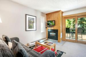 a living room with a couch and a fireplace at Lift House Lodge, Pet Friendly Studio Condo in Vail