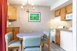 a kitchen with a table and chairs in a room at Lift House Lodge, Pet Friendly Studio Condo in Vail