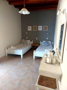 a room with two beds and a table at Agia Roumeli Hotel in Agia Roumeli