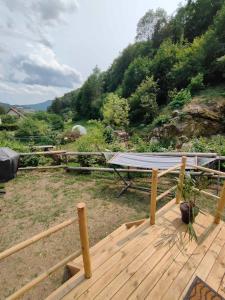 a picnic table on a deck with a view of a mountain at la Yourte des Bibis in Fréland