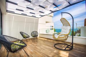a room with chairs and a view of the ocean at Olive Villas Beach Hotel in Sozopol